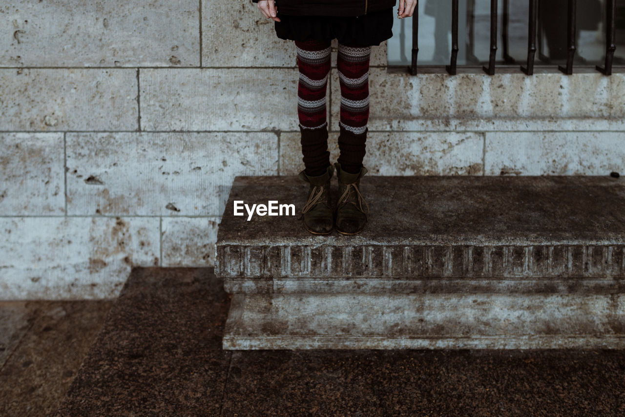 Low section of person standing on steps