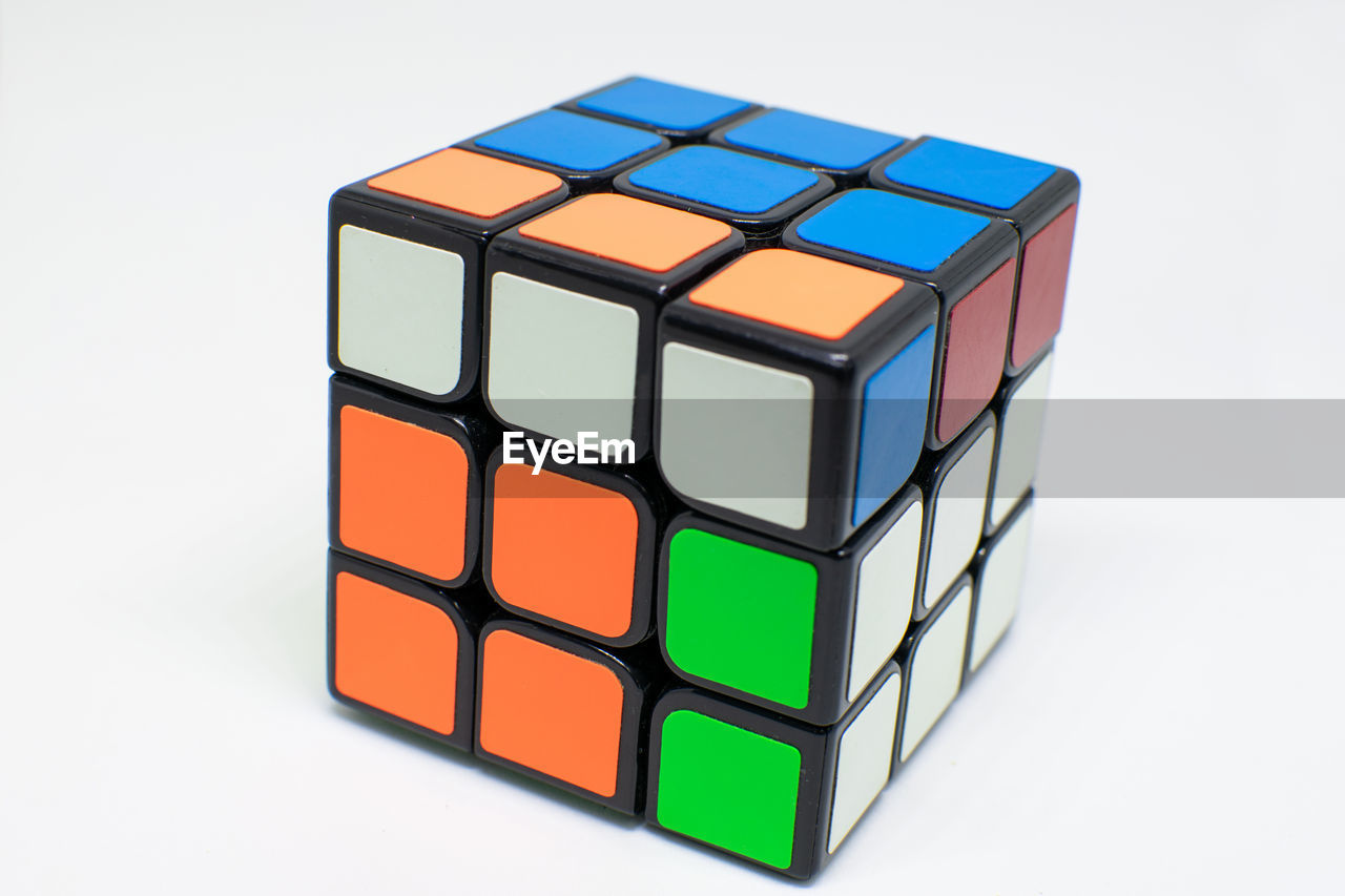 rubik's cube, cube shape, multi colored, mechanical puzzle, toy, geometric shape, block shape, shape, block, puzzle, white background, indoors, toy block, studio shot, no people, three dimensional, cut out, business, pattern