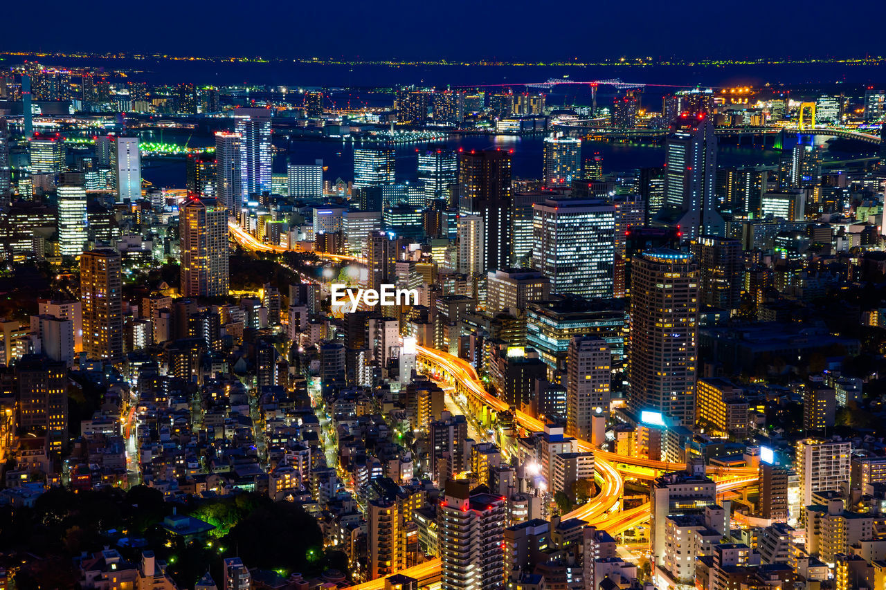 HIGH ANGLE VIEW OF ILLUMINATED CITY BUILDINGS