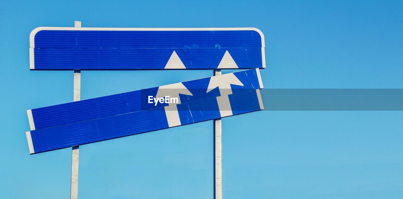 LOW ANGLE VIEW OF ROAD SIGN AGAINST CLEAR SKY