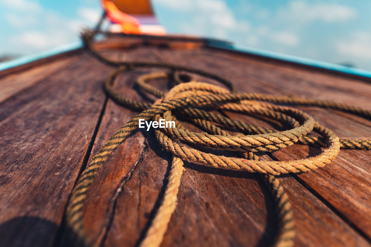 Close-up of rope tied on wood