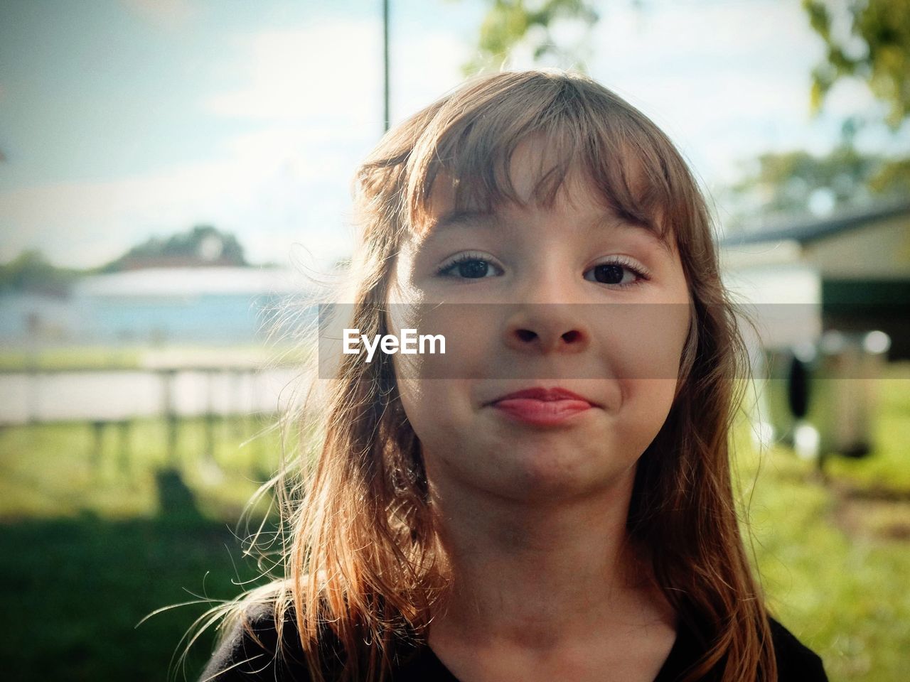 Close-up portrait of girl standing outdoors