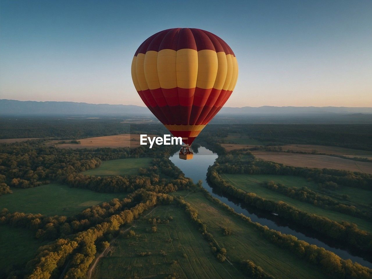 hot air balloons flying over landscape against sky