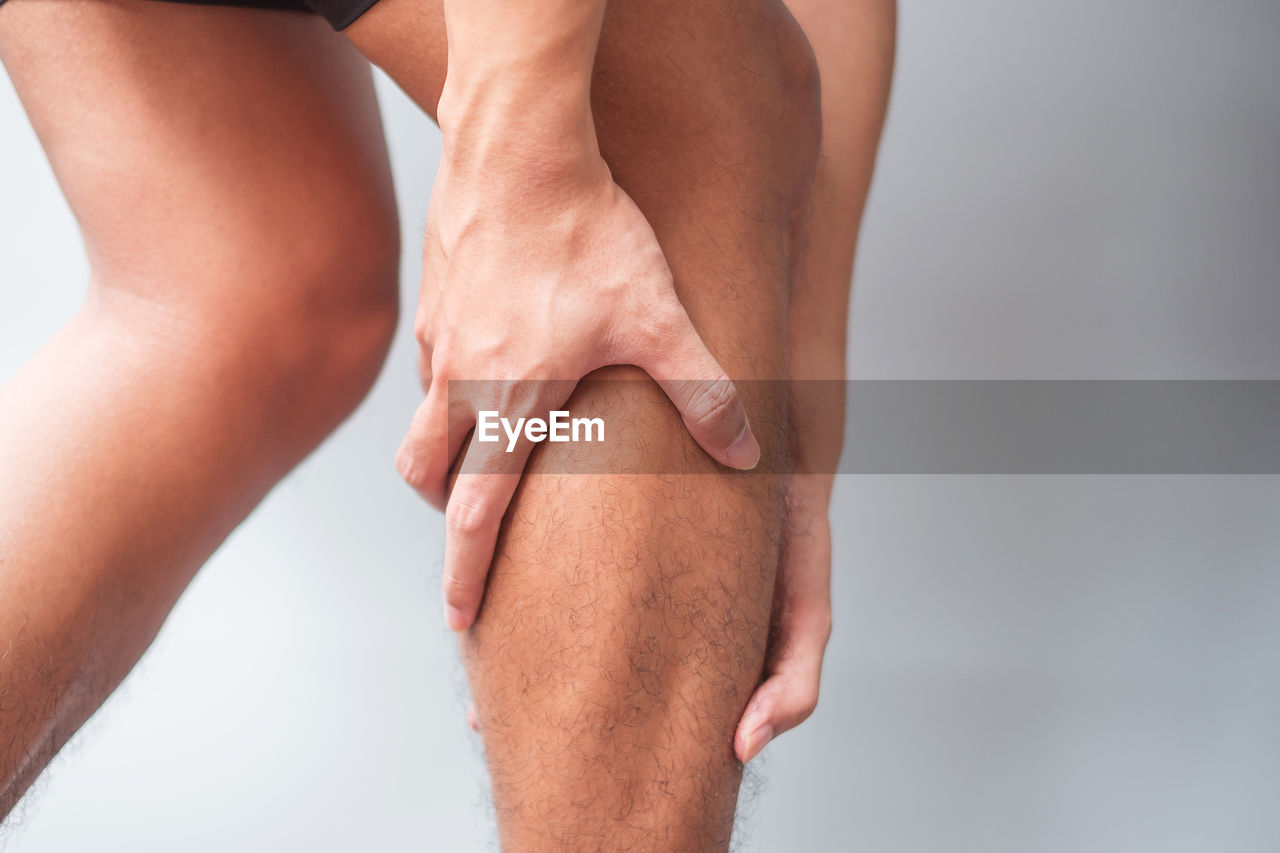 LOW SECTION OF PERSON LEGS ON FLOOR