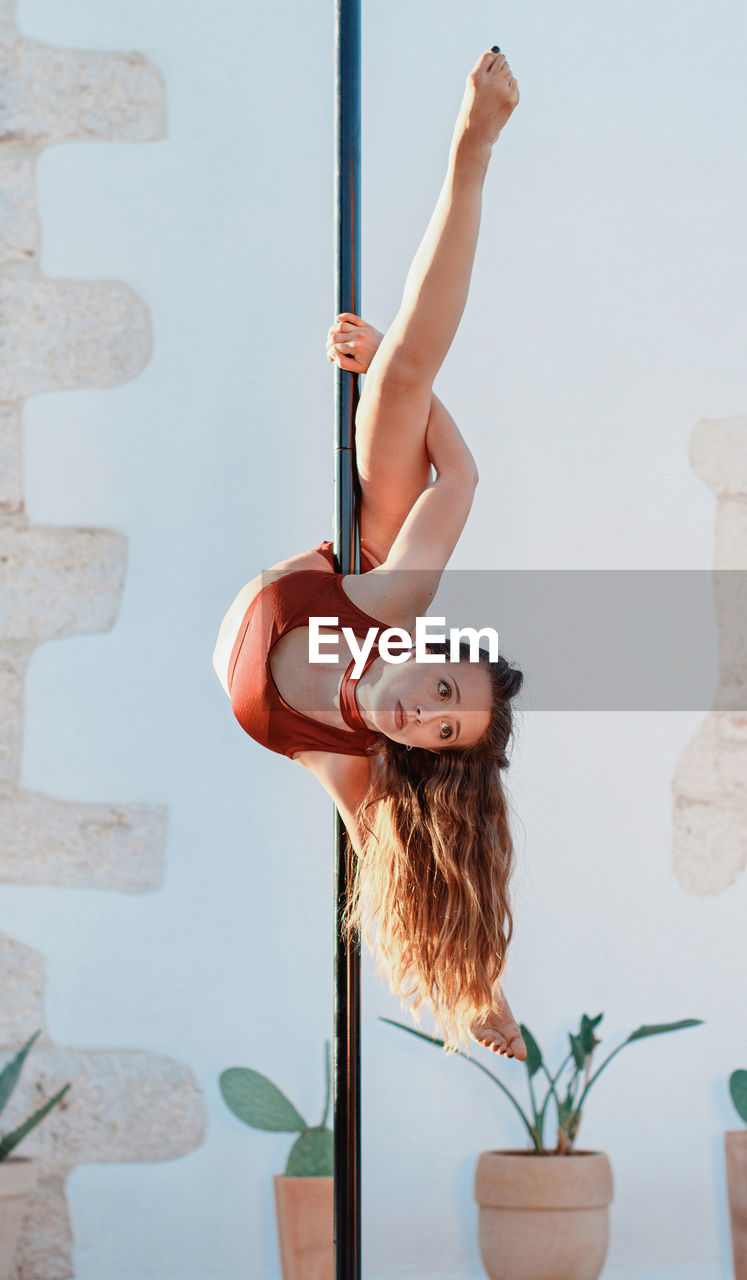 Full length of girl hanging on pole