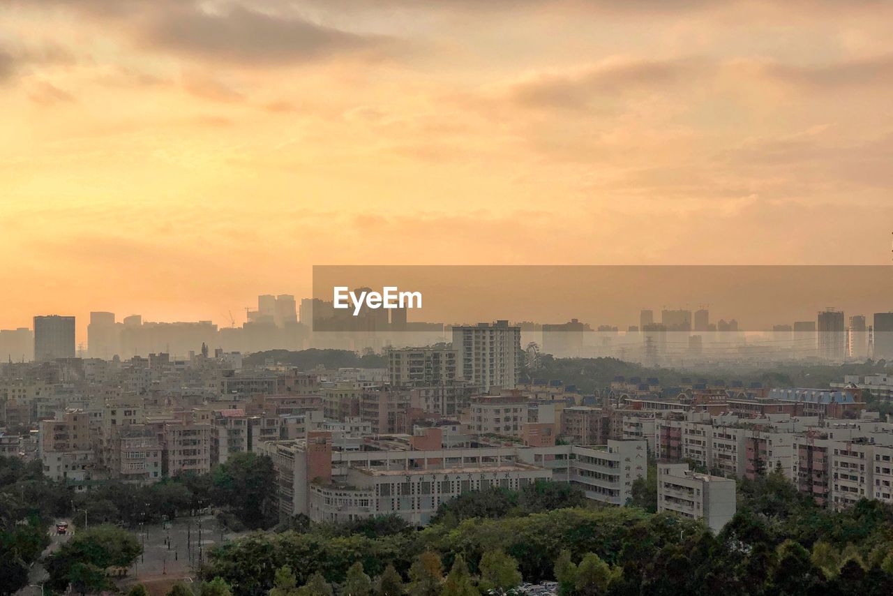 High angle view of buildings against sky during sunset