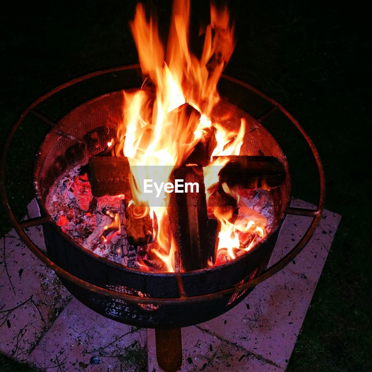 Close-up of lit fire pit at night