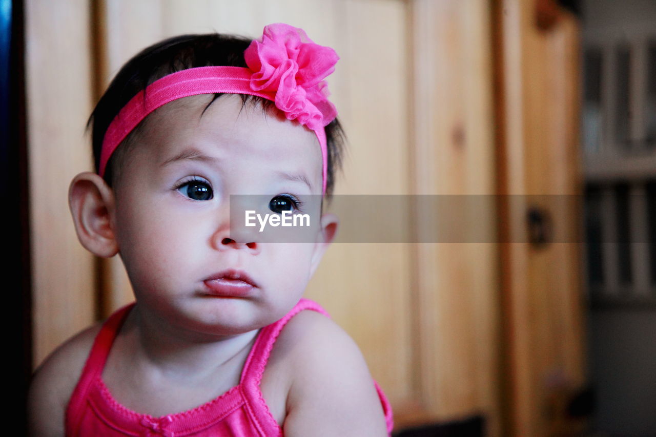 Close-up of cute baby girl wearing pink headband