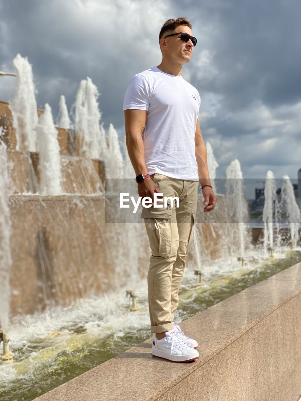 Full length of young man standing against sky