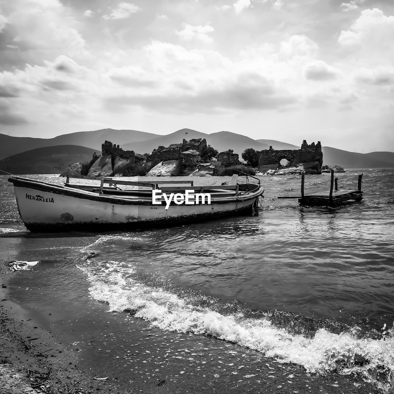 BOATS MOORED ON SEA BY MOUNTAIN AGAINST SKY