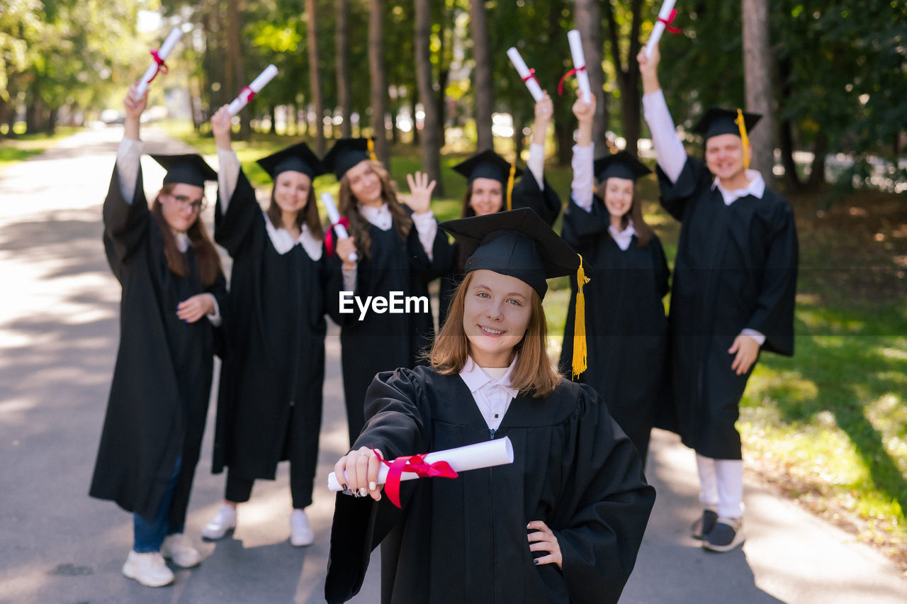 portrait of smiling woman wearing graduation gown