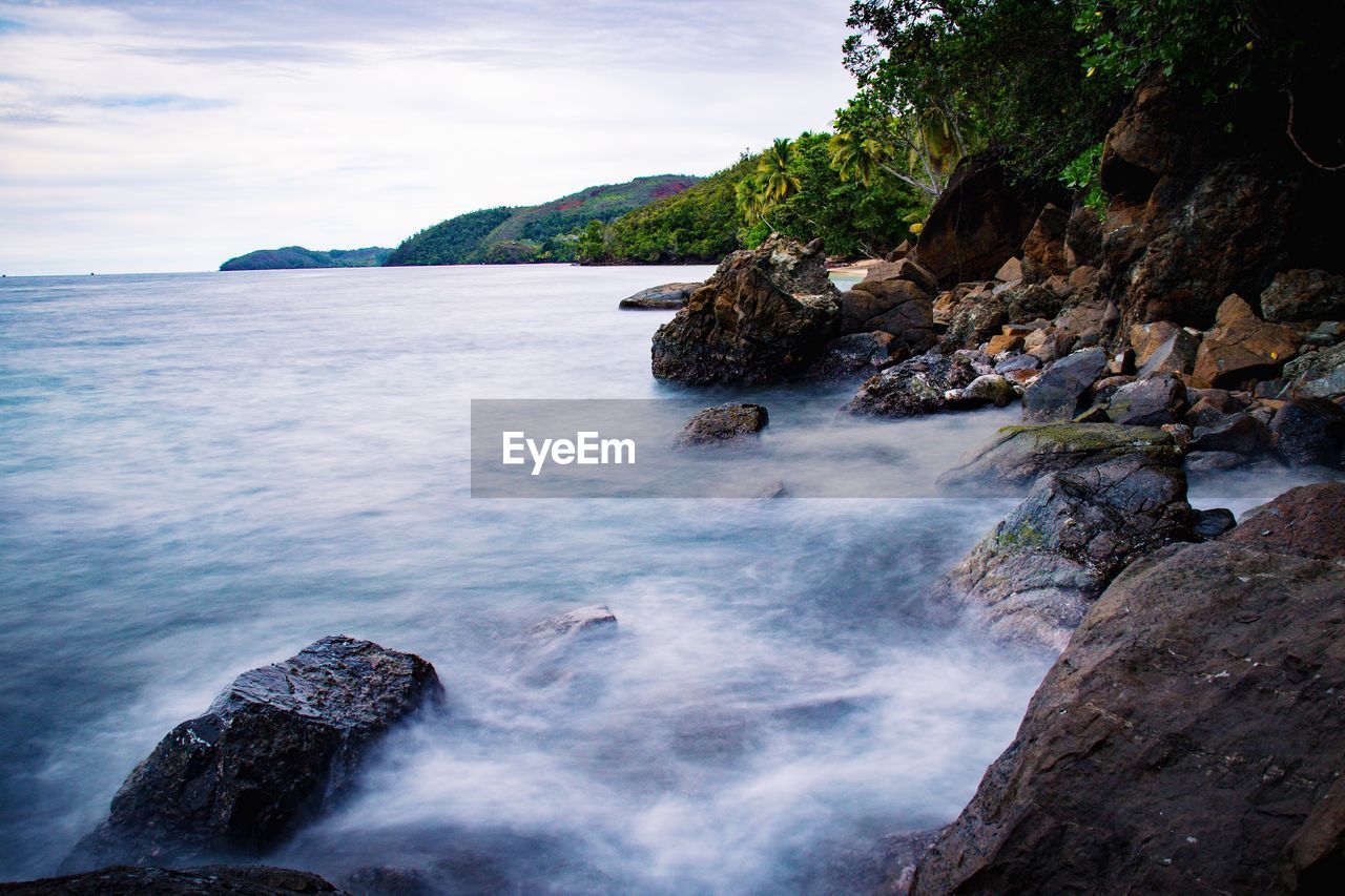 ROCKS IN SEA AGAINST SKY