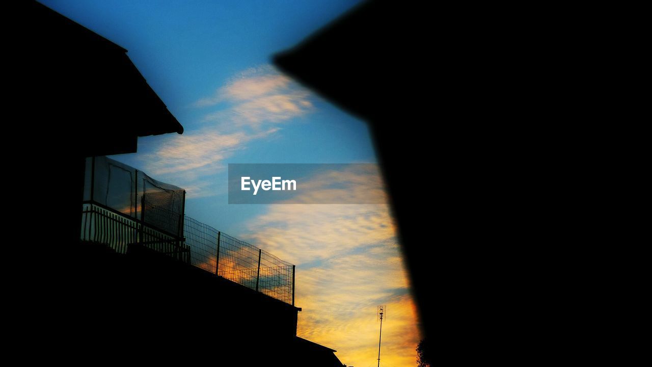 Low angle view of silhouette buildings against sky during sunset