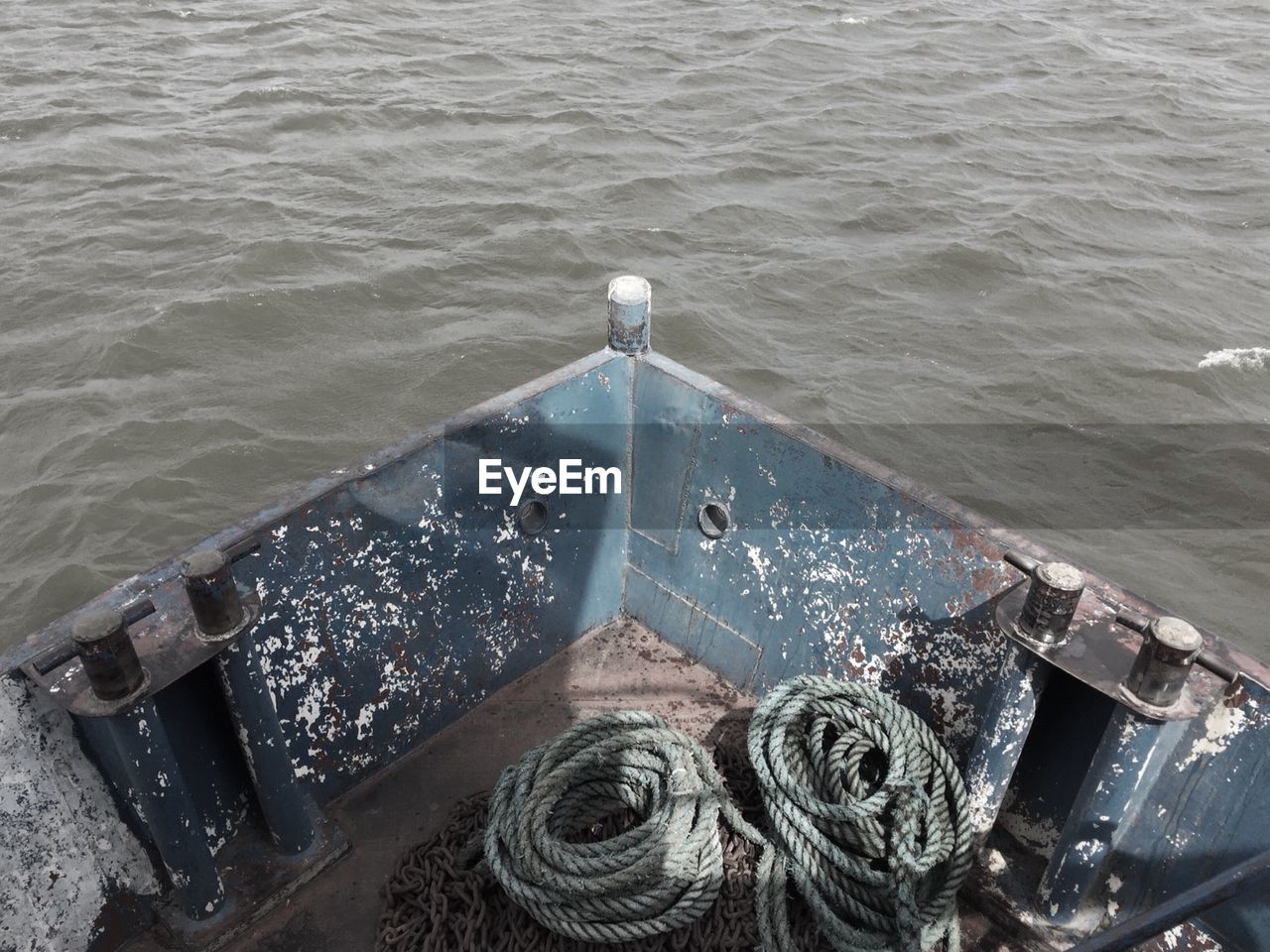 High angle view of ropes in cropped boat moving over river