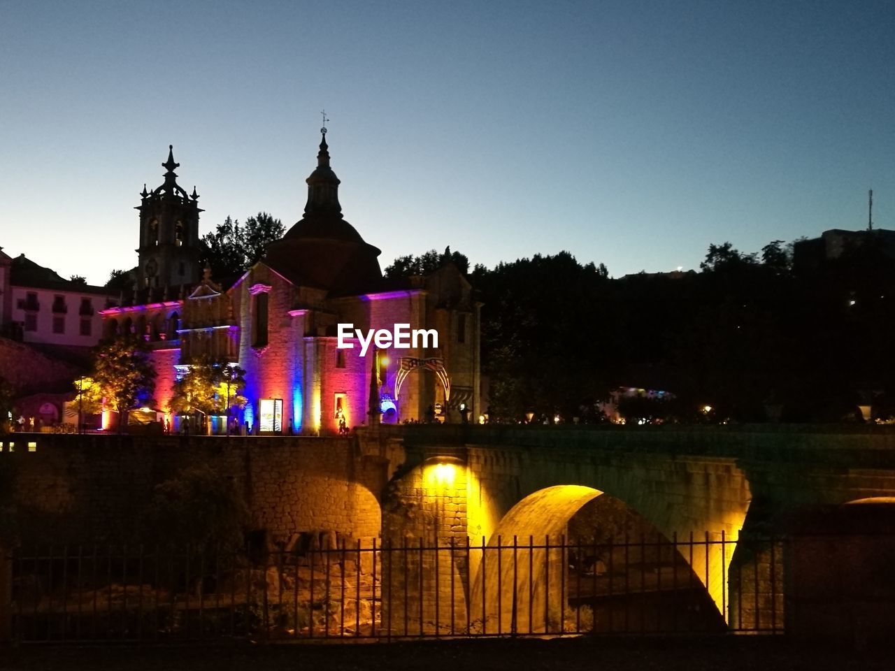 ILLUMINATED CATHEDRAL AGAINST CLEAR SKY AT NIGHT