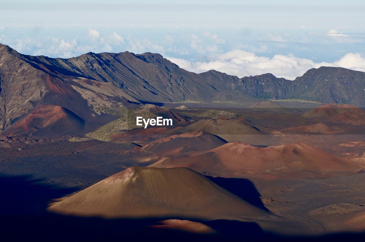 Scenic view of volcanic mountains against sky