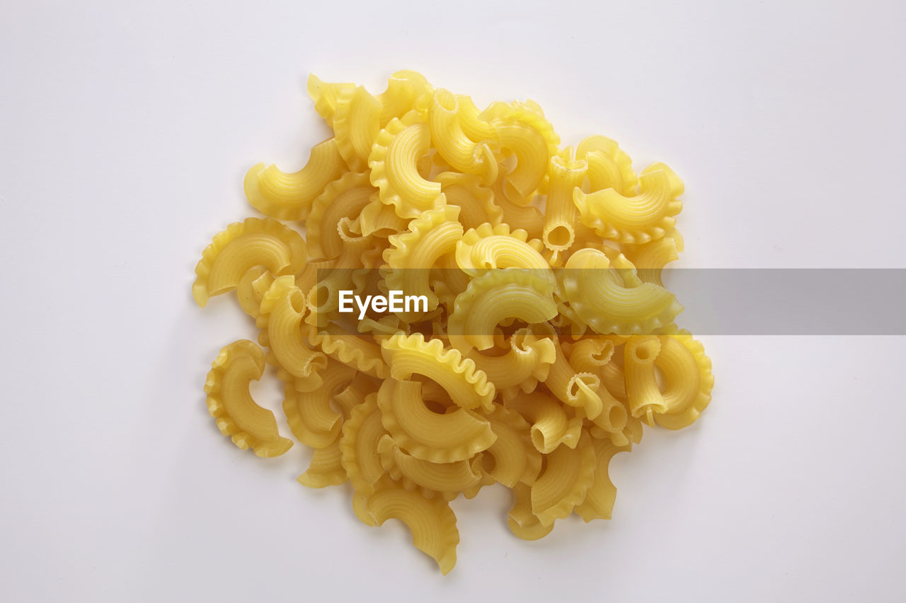 Close-up of macaroni on white background