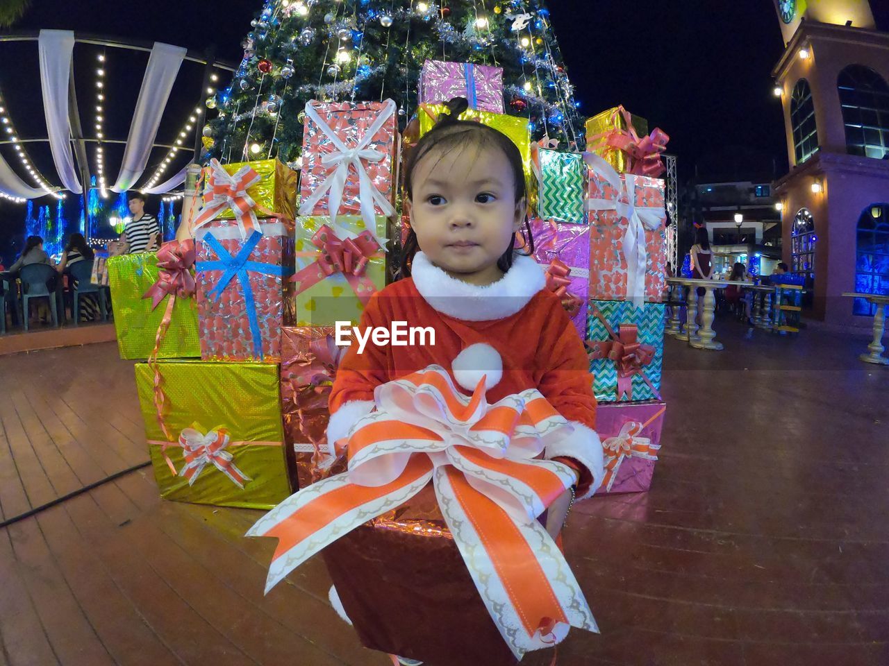 Kid with gift boxes at christmas park