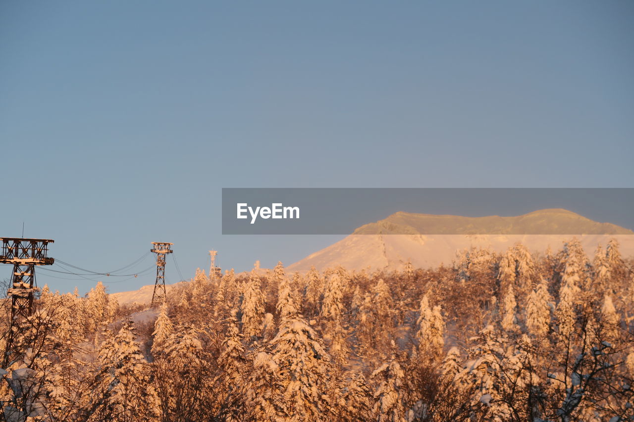 Scenic view of snowcapped mountains against clear sky