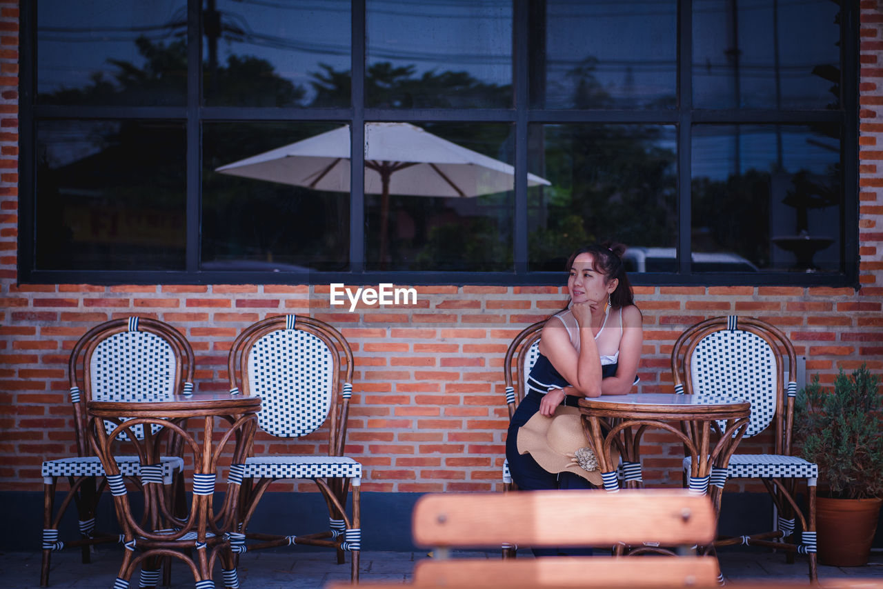 Woman sitting at table in restaurant