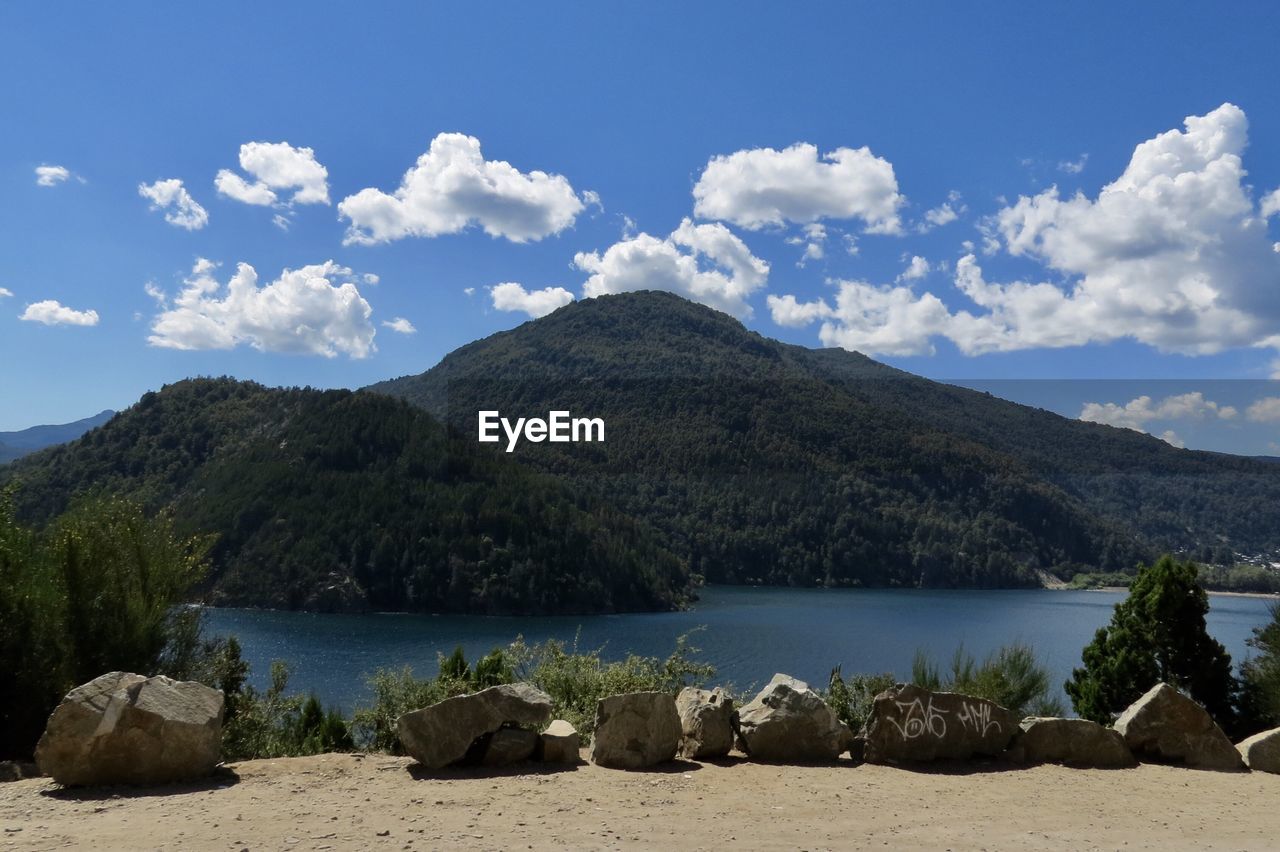 Scenic view of sea and mountains against sky