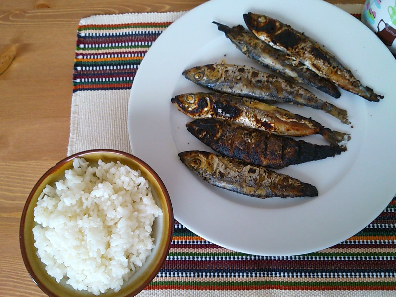 Close-up of prepared fish and bowl of rice