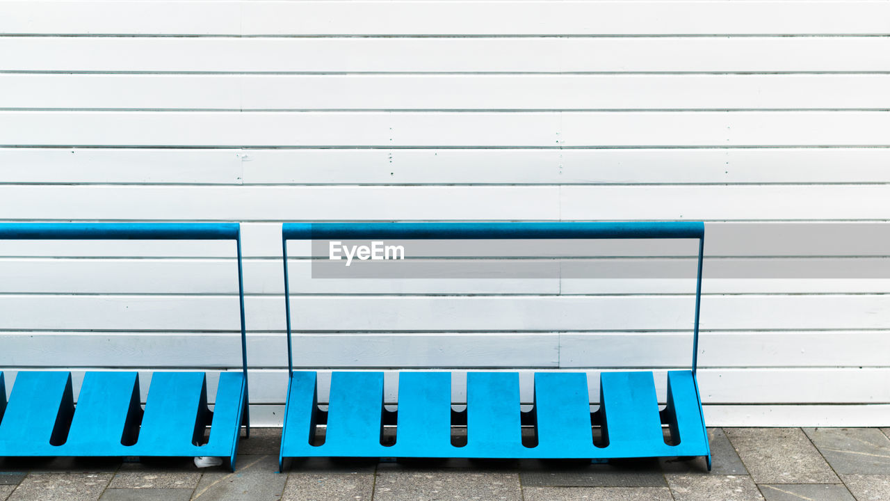Bicycle racks against corrugated wall