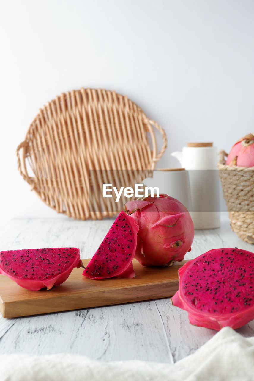 pink, food, food and drink, indoors, basket, container, no people, still life, heart, freshness, sweet food, studio shot, high angle view, petal, wicker, wood