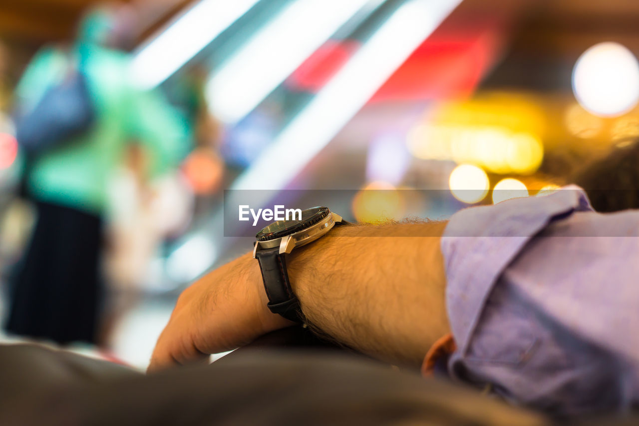 Cropped hand of man with wristwatch