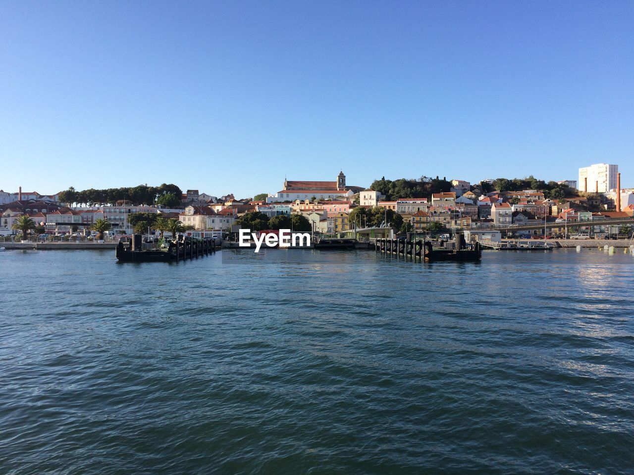 Scenic view of river against clear blue sky