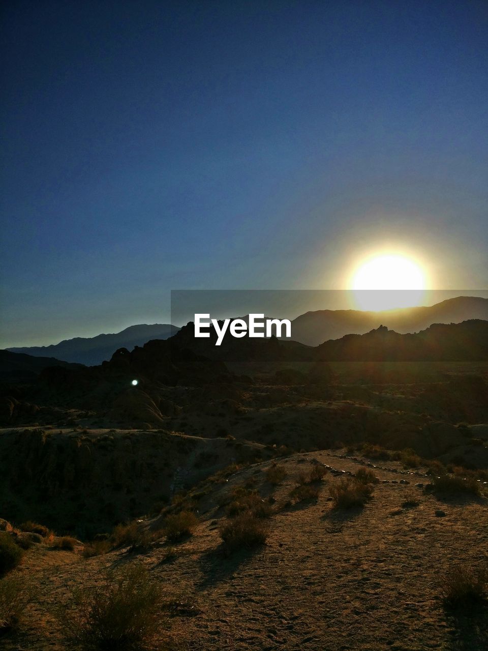 SCENIC VIEW OF MOUNTAINS AGAINST CLEAR SKY AT SUNSET