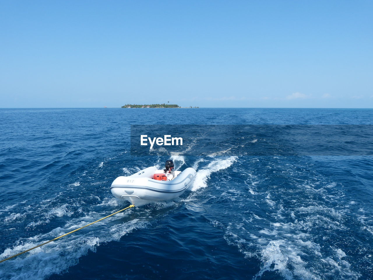 High angle view of boat tied to rope on sea against sky