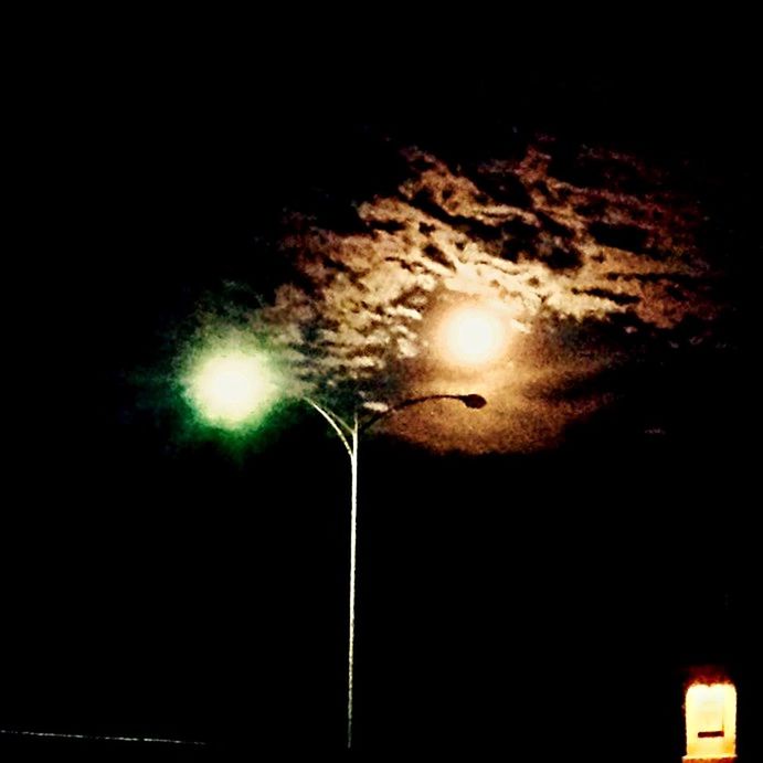 LOW ANGLE VIEW OF LIT LAMP POST AT NIGHT