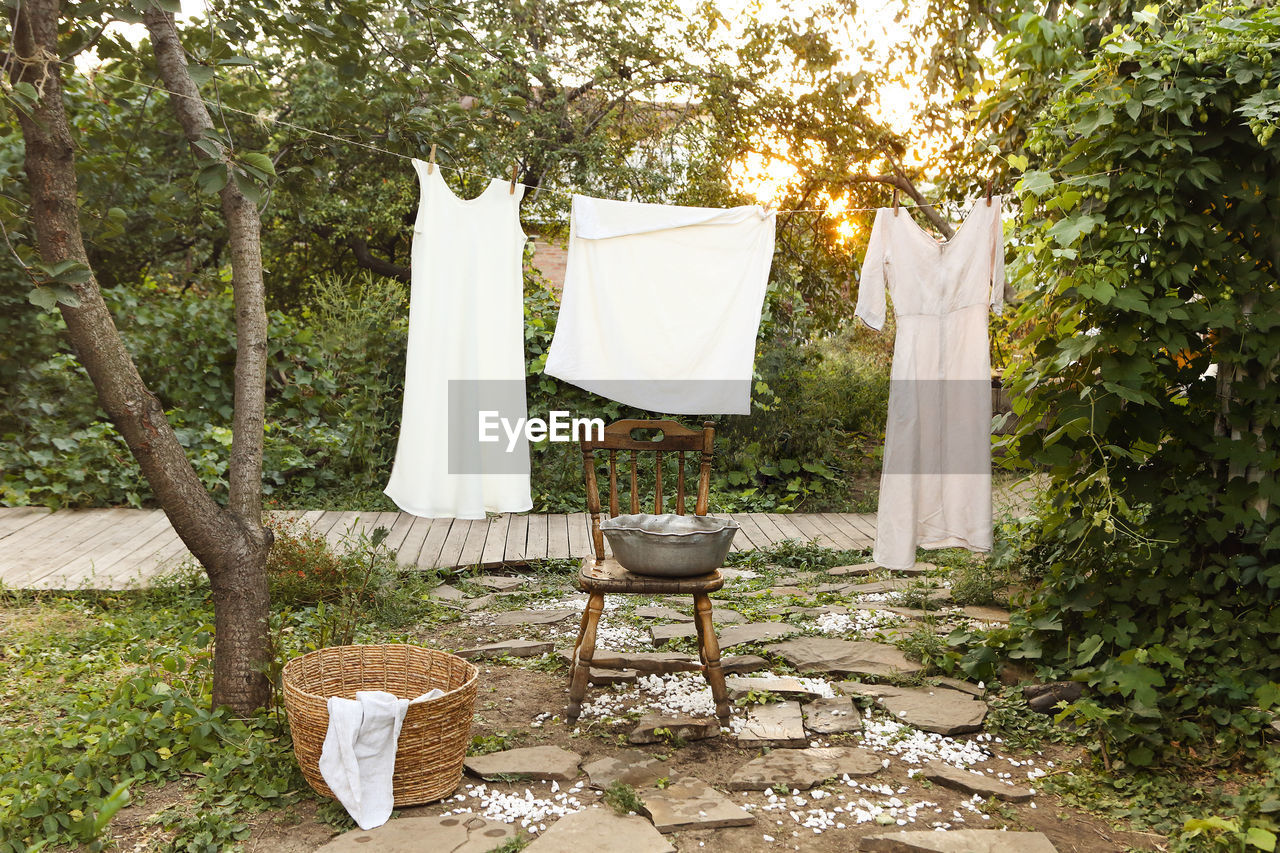 CLOTHES DRYING ON CHAIR IN BACKYARD