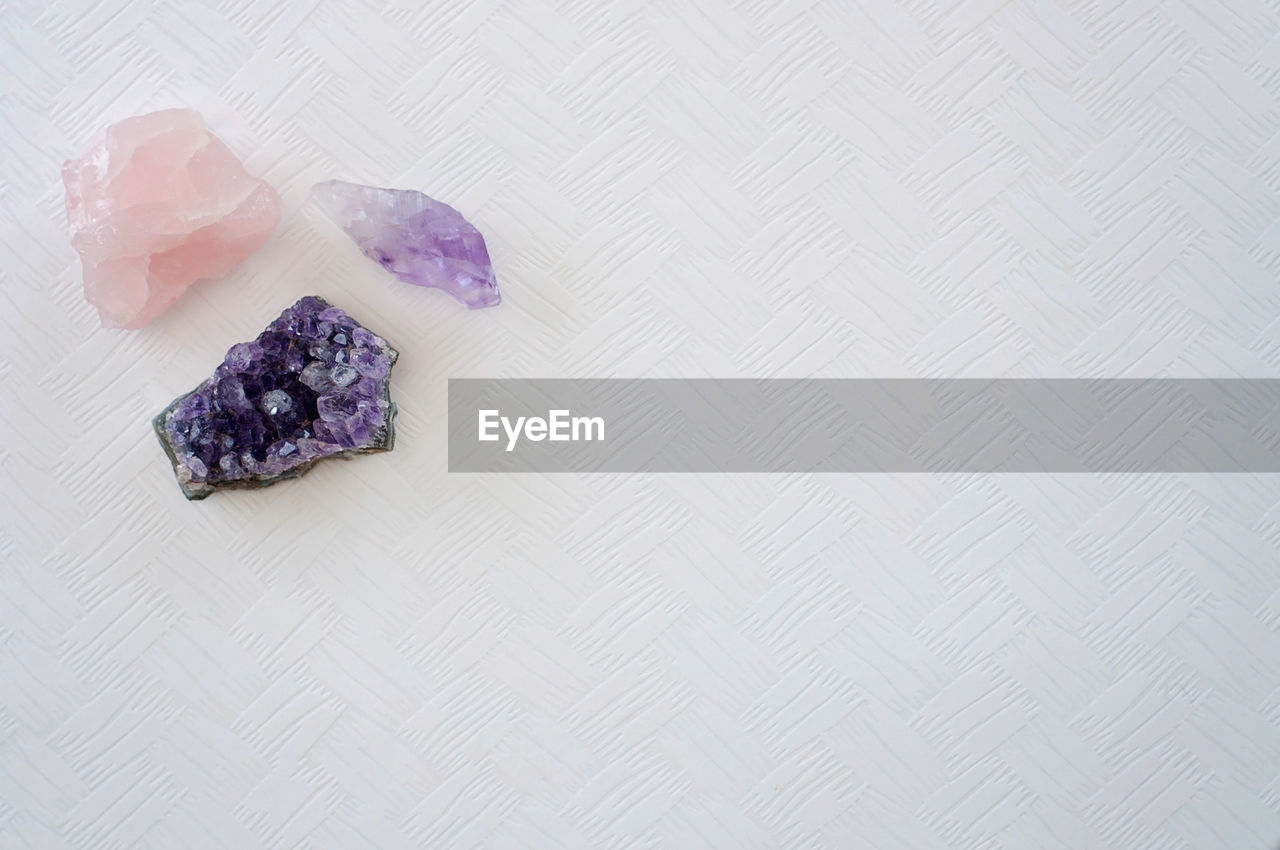 High angle view of purple gemstones on table