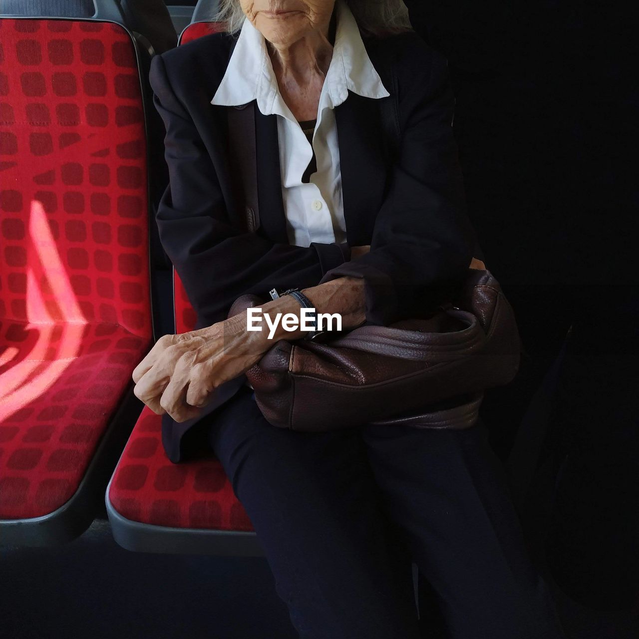 Old fashion lady in the bus with white collar and costume