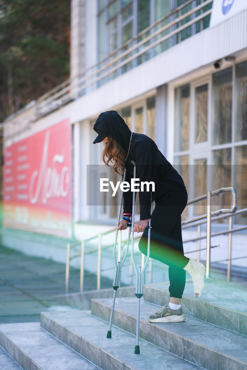 low section of woman standing on street