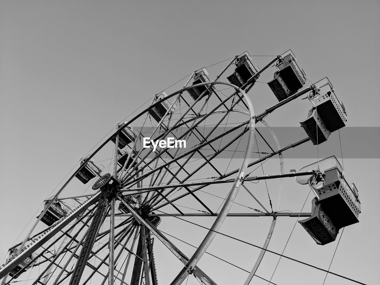 Low angle view of ferris wheel against clear sky