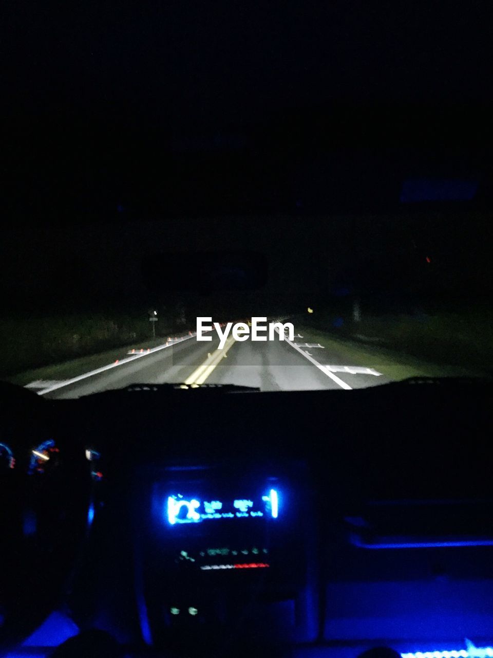 ROAD PASSING THROUGH CAR WINDSHIELD