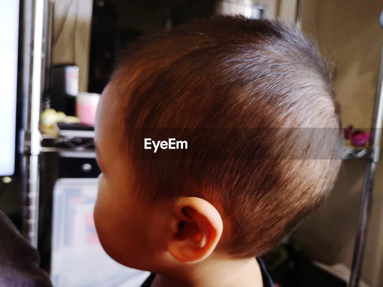 human hair, hairstyle, childhood, headshot, child, one person, portrait, human head, indoors, hairdresser, close-up, human face, hair color, men, toddler, brown hair, person, nose, focus on foreground, innocence, barber shop, baby, day, lifestyles, looking