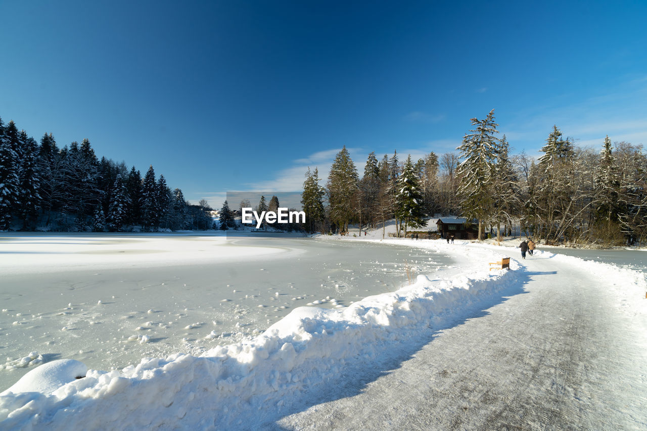 Snow covered land against sky