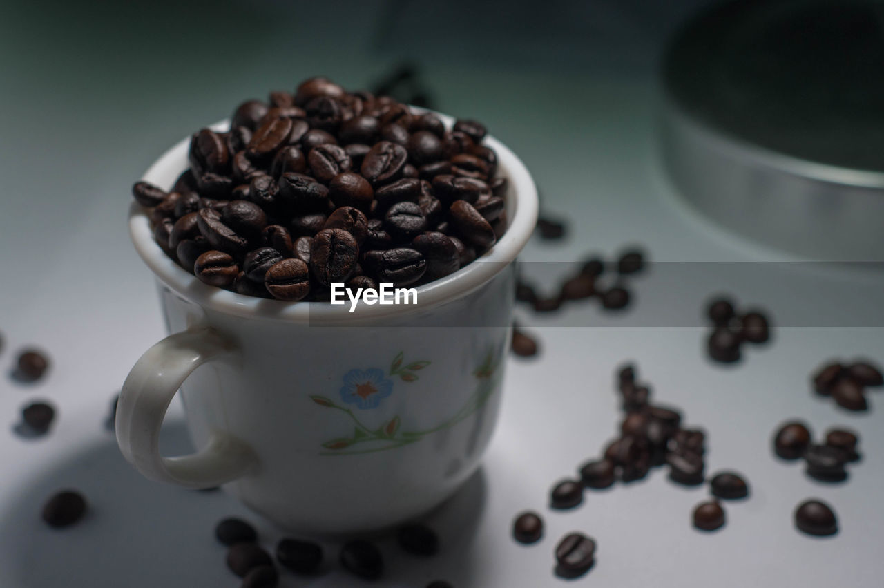 CLOSE-UP OF COFFEE BEANS IN CUP