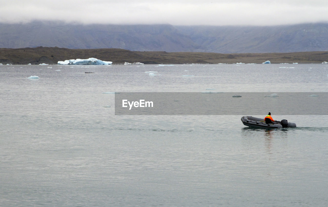 Boat going through a lagoon in iceland with a retreating glacier
