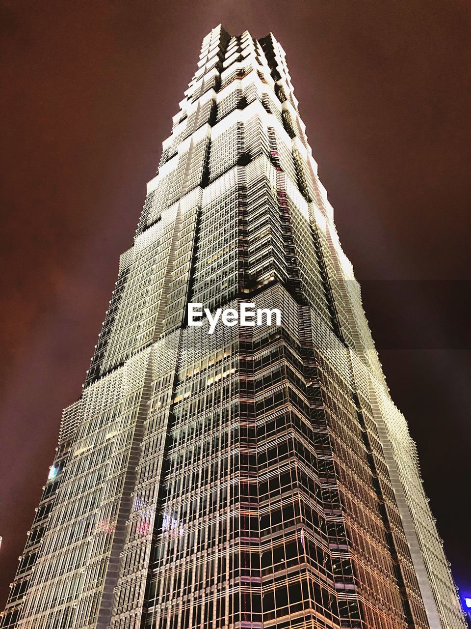 LOW ANGLE VIEW OF ILLUMINATED BUILDING AGAINST SKY