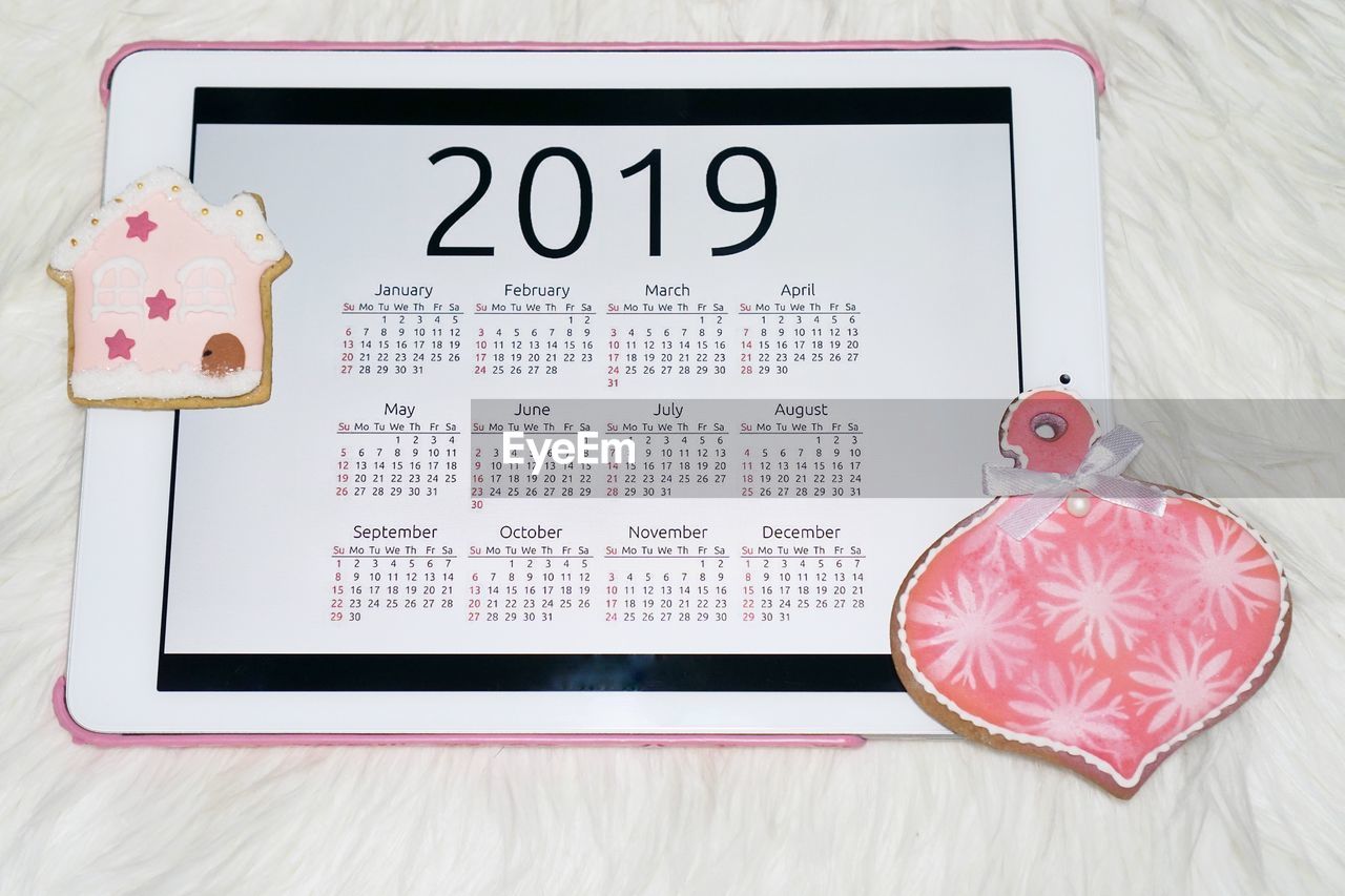 Close-up of digital tablet showing calendar on table