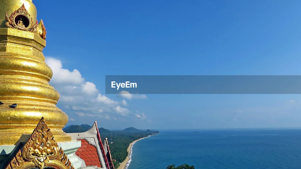 Cropped buddha statue of calm blue sea