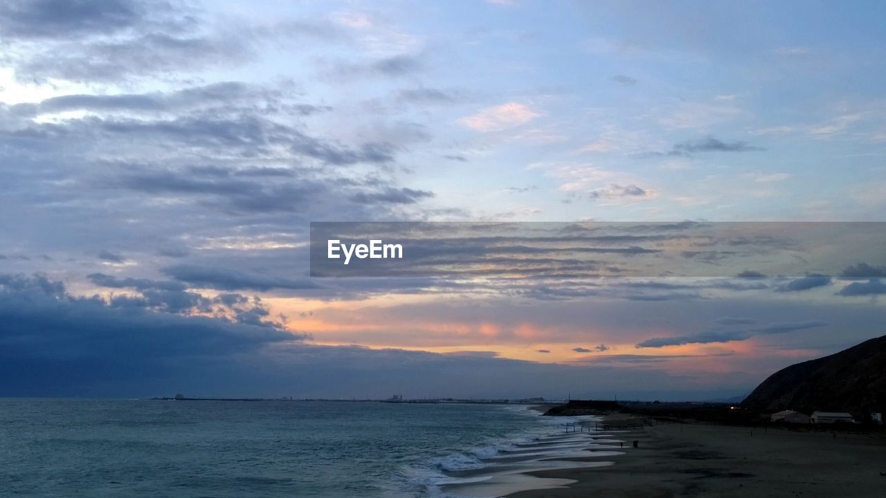 SCENIC VIEW OF SEA AT SUNSET