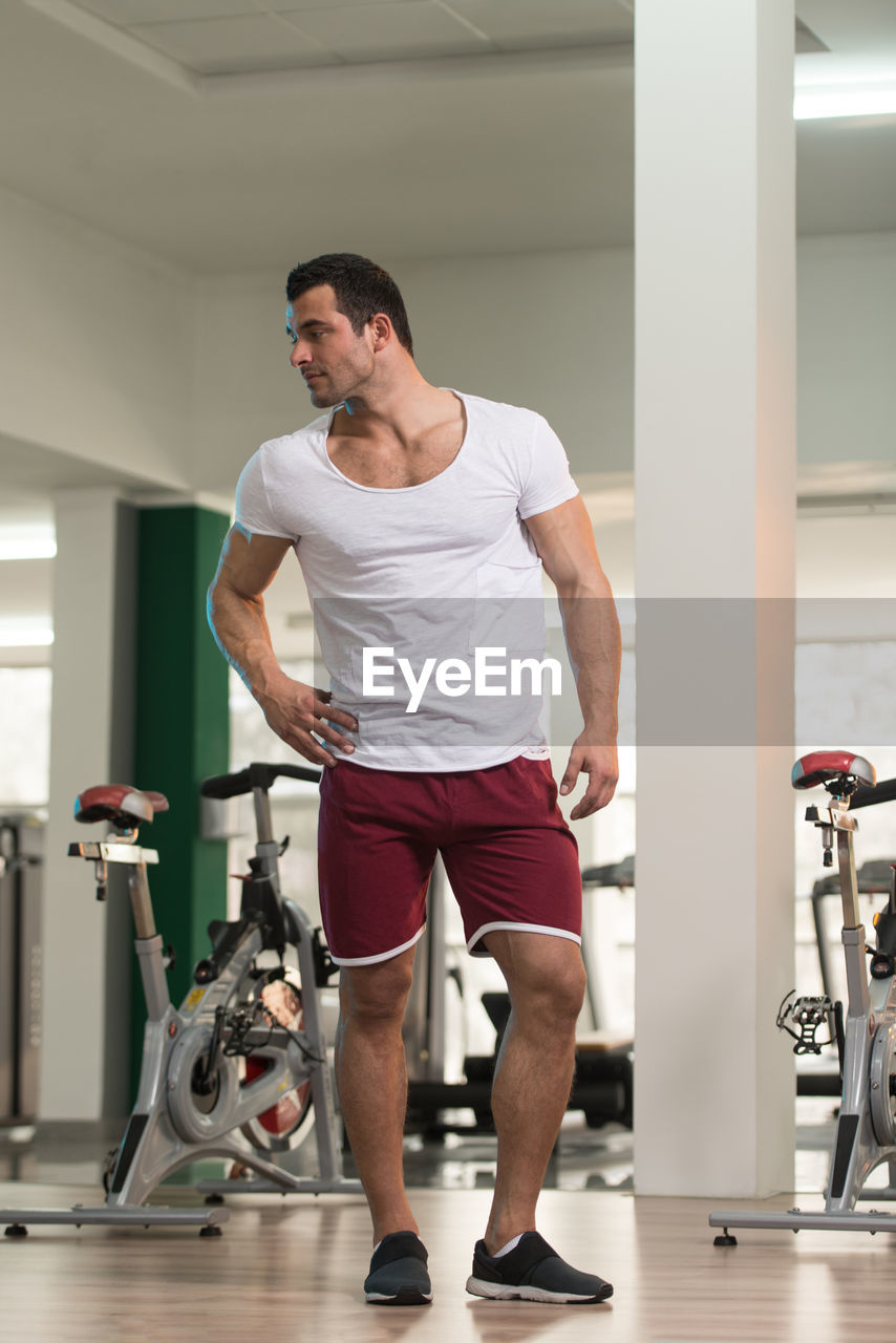 Muscular man standing in gym