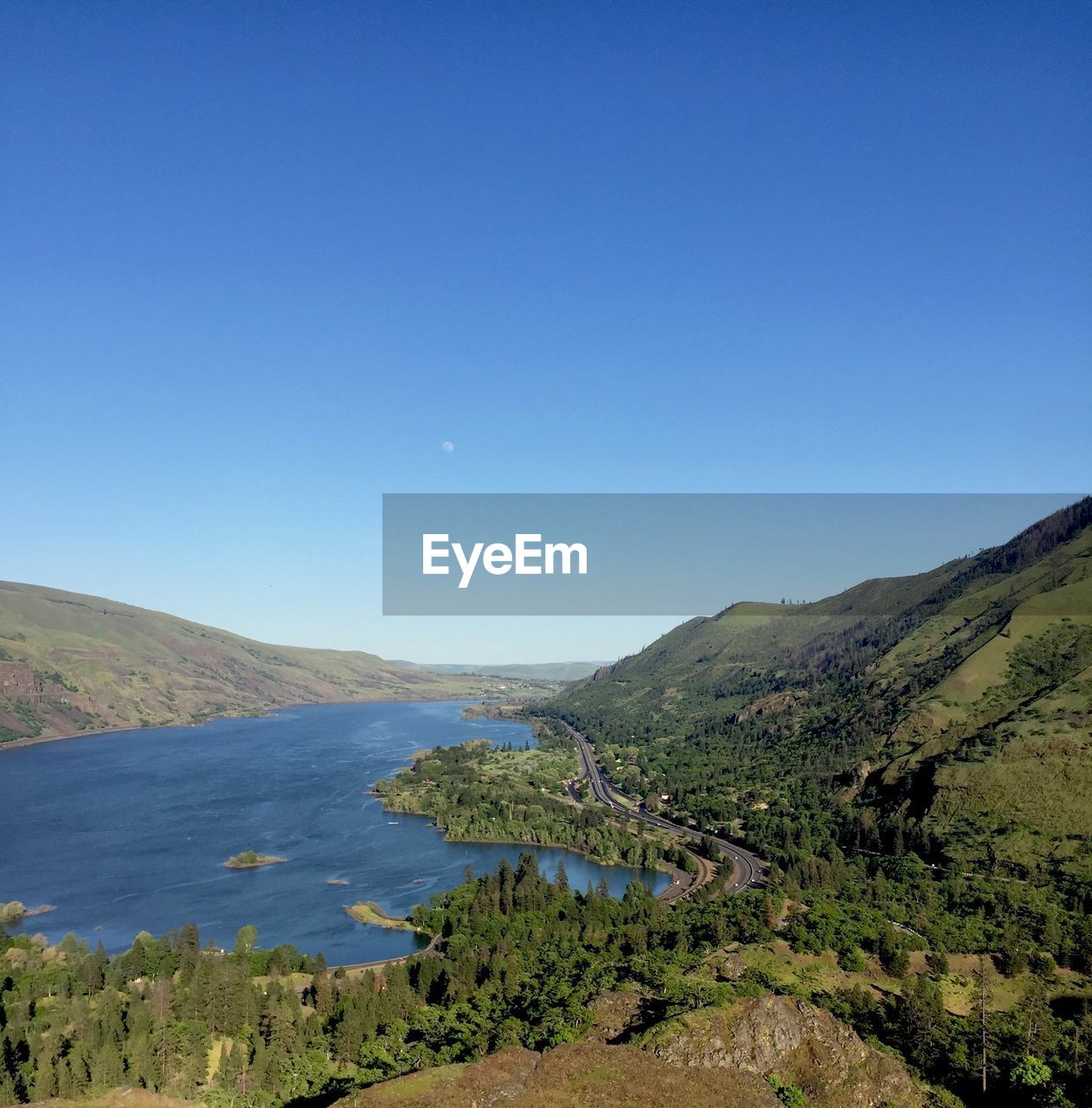 Scenic view of mountains against clear blue sky