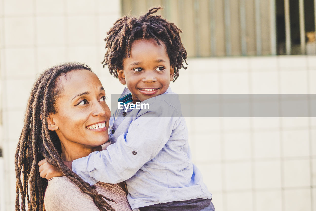 PORTRAIT OF HAPPY MOTHER WITH DAUGHTER